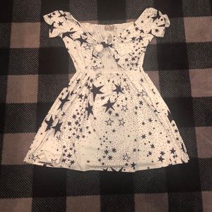 An off the shoulders mini dress with stars and tie